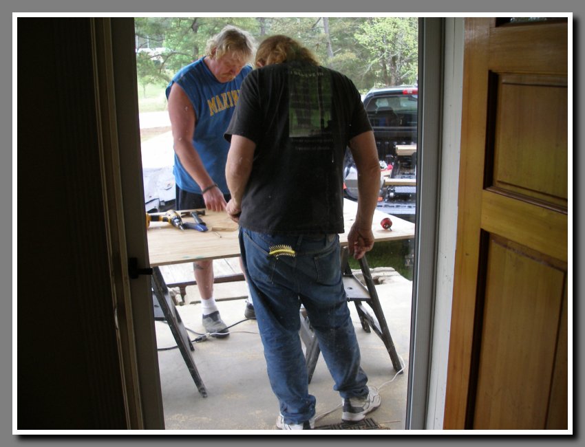 Dave and Joe cutting plywood on front porch