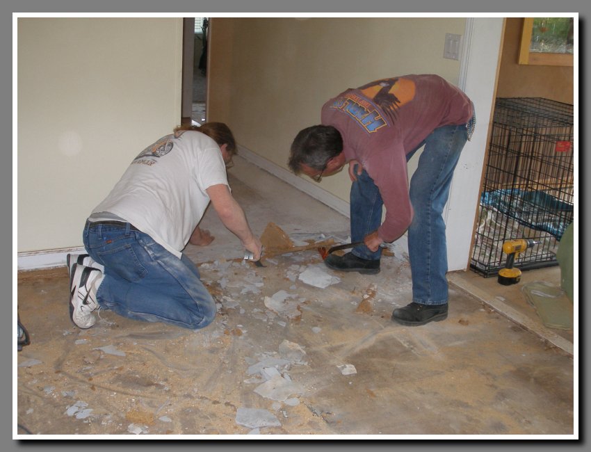 Dave and Terry removing fiberboard that was under black plastic